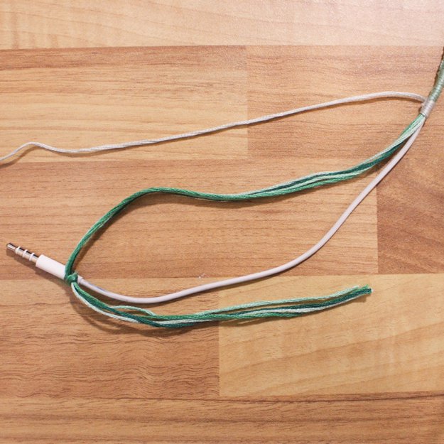 When you near the end with your last color, take the remaining strands and tie them at a knot around the base of the cord, leaving out the strand you are knotting with. Continue knotting with this strand, covering the tail of the end knot until you reach the base.