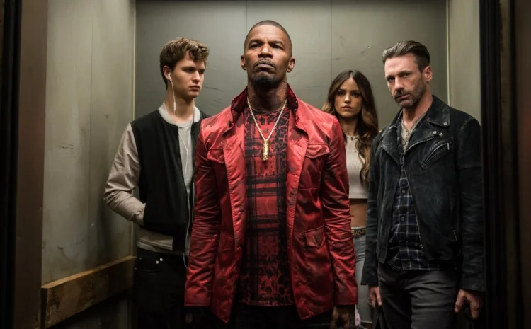 Ansel Elgort, Jamie Foxx, Elza Gonzalez and Jon Hamm enjoy a post-heist elevator ride in Baby Driver.