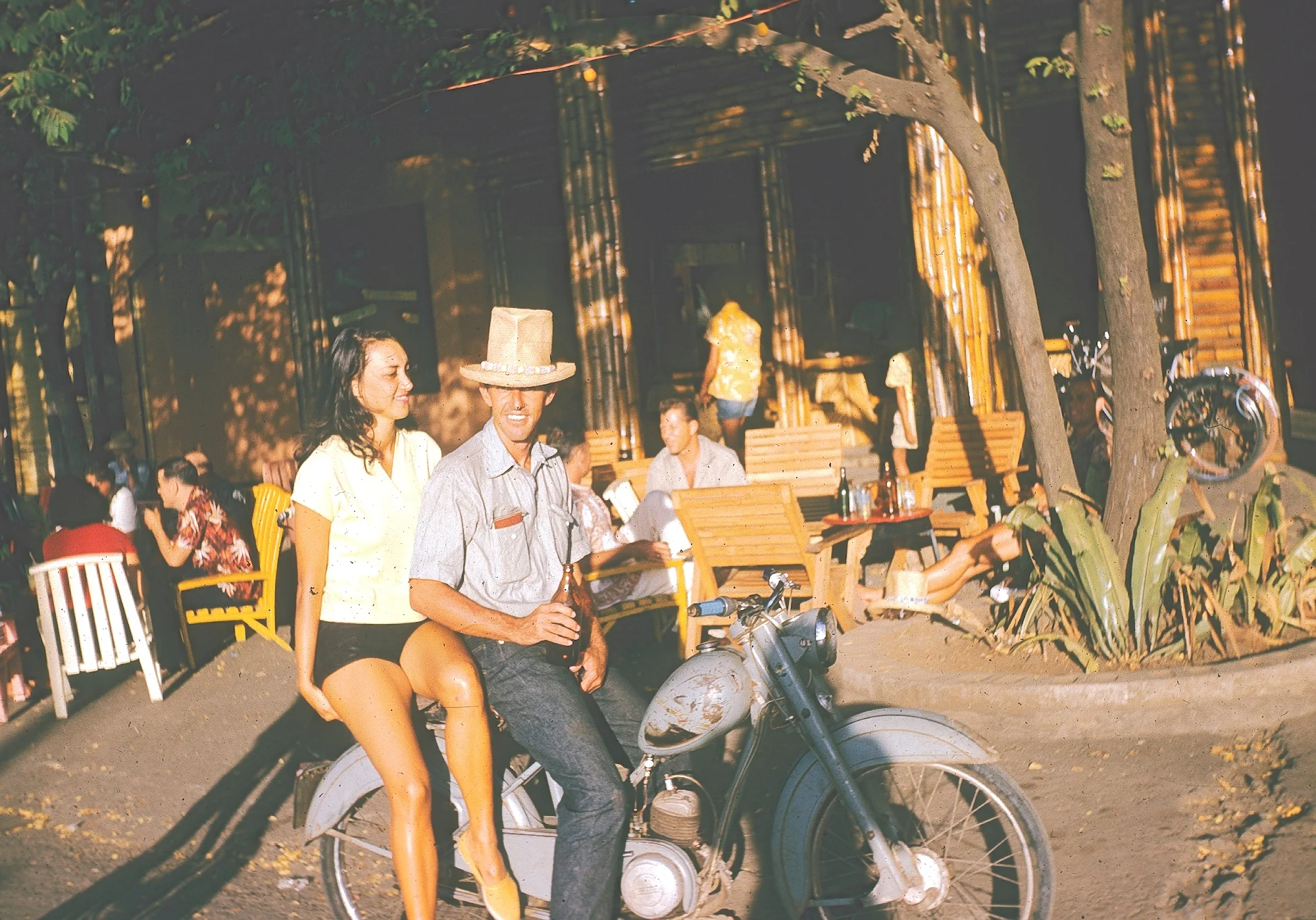 Dick Metz and a Tahitian belle scooting around the Society Islands in 1958.