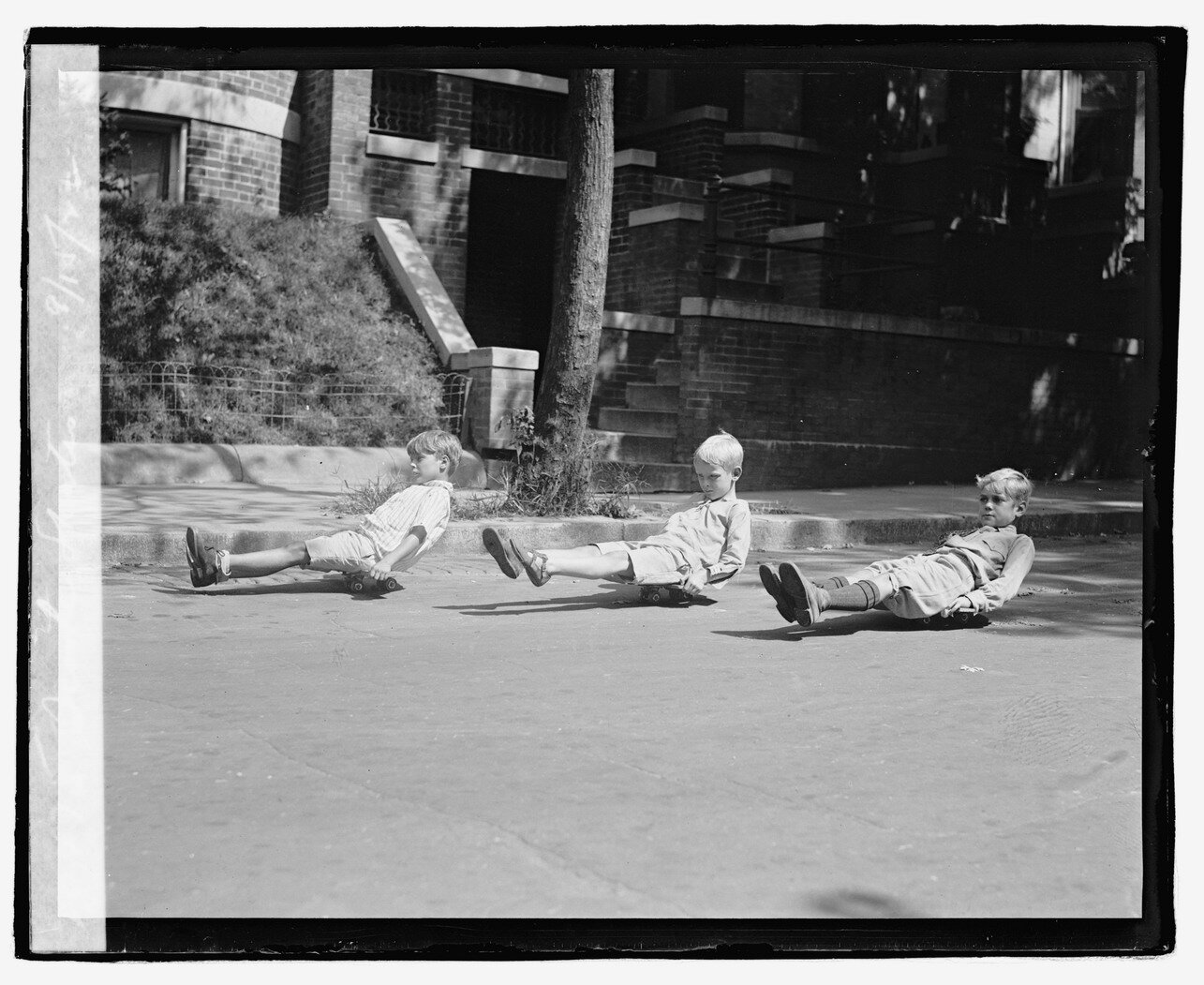 Butt boarding is an ancestor of skateboarding. These kids are in Pasadena.