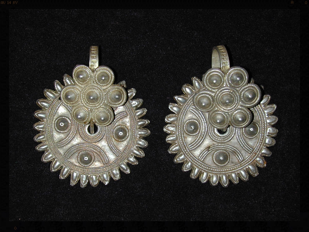 Yi silver earrings, China, early 20th century.