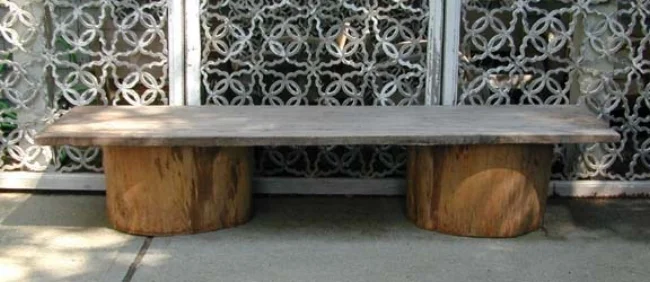 Low table of solid slab of old teak wood and cut antique wood water barrels.