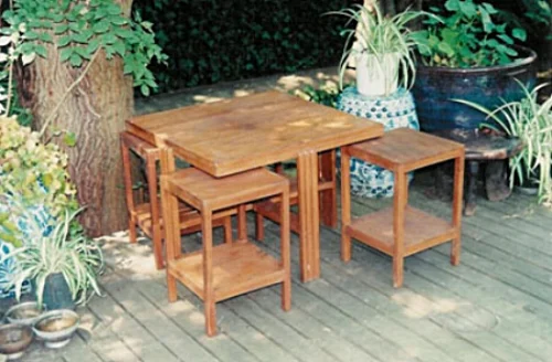 Teak wood table with four nesting side tables or stools, Siam, circa 1930s.