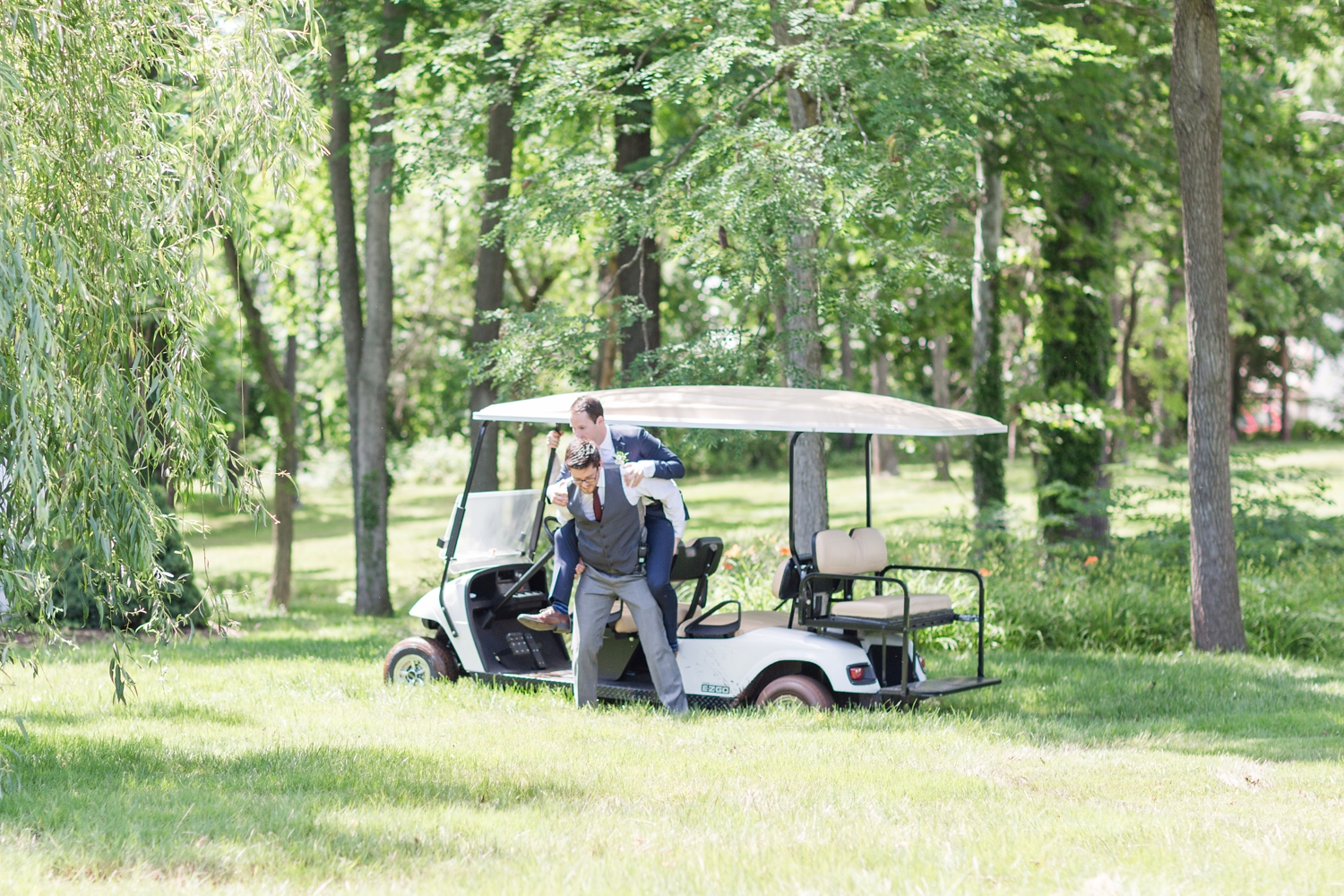  This was crazy!! The golf cart got stuck in the mud so Kevin separately carried both the groom and bride to solid ground so they wouldn’t get dirty. I was so thankful Emily’s dress didn’t get muddy!! Kevin to the rescue. 