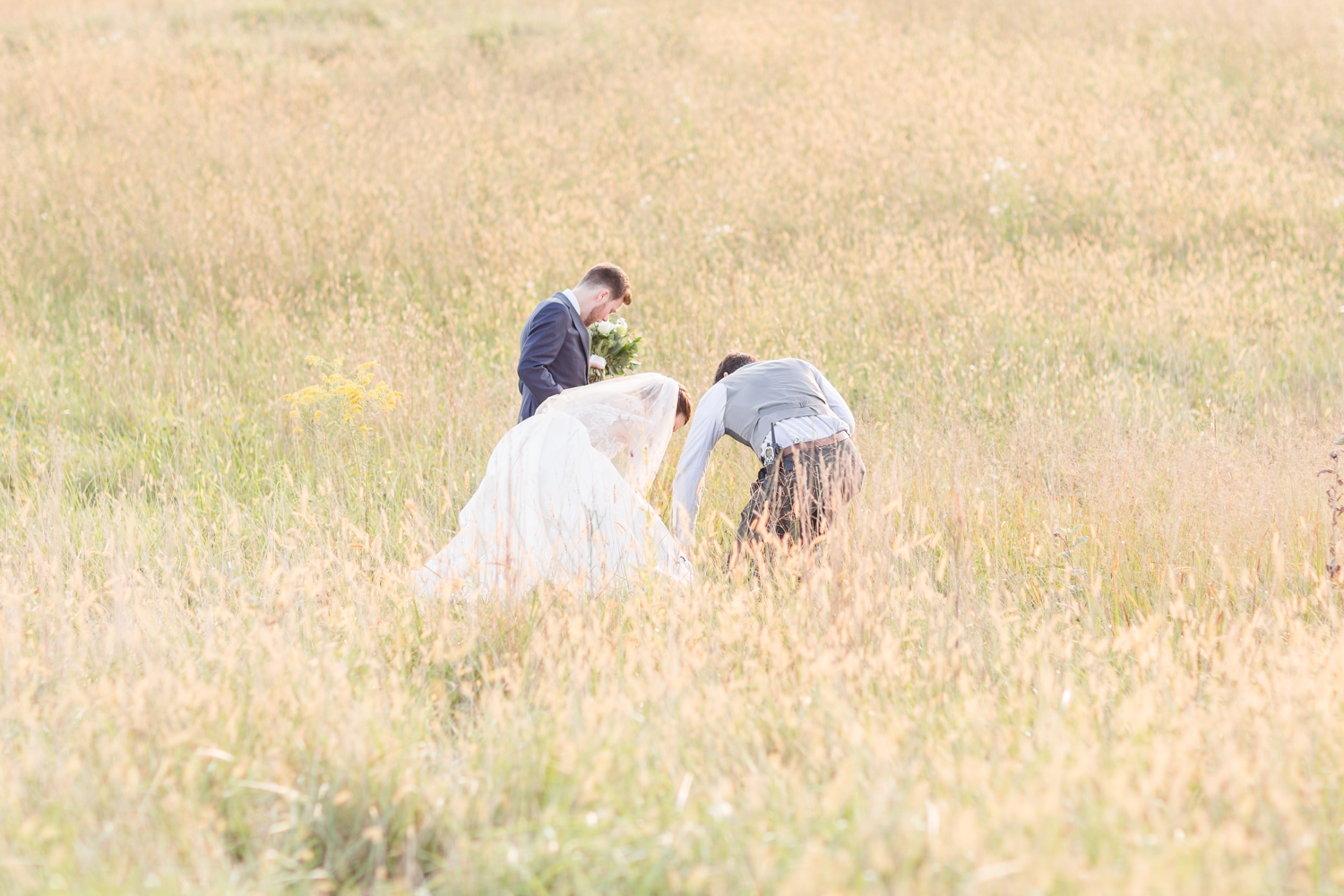 Kevin helping to make sure Kristen’s dress didn’t get caught in the field!