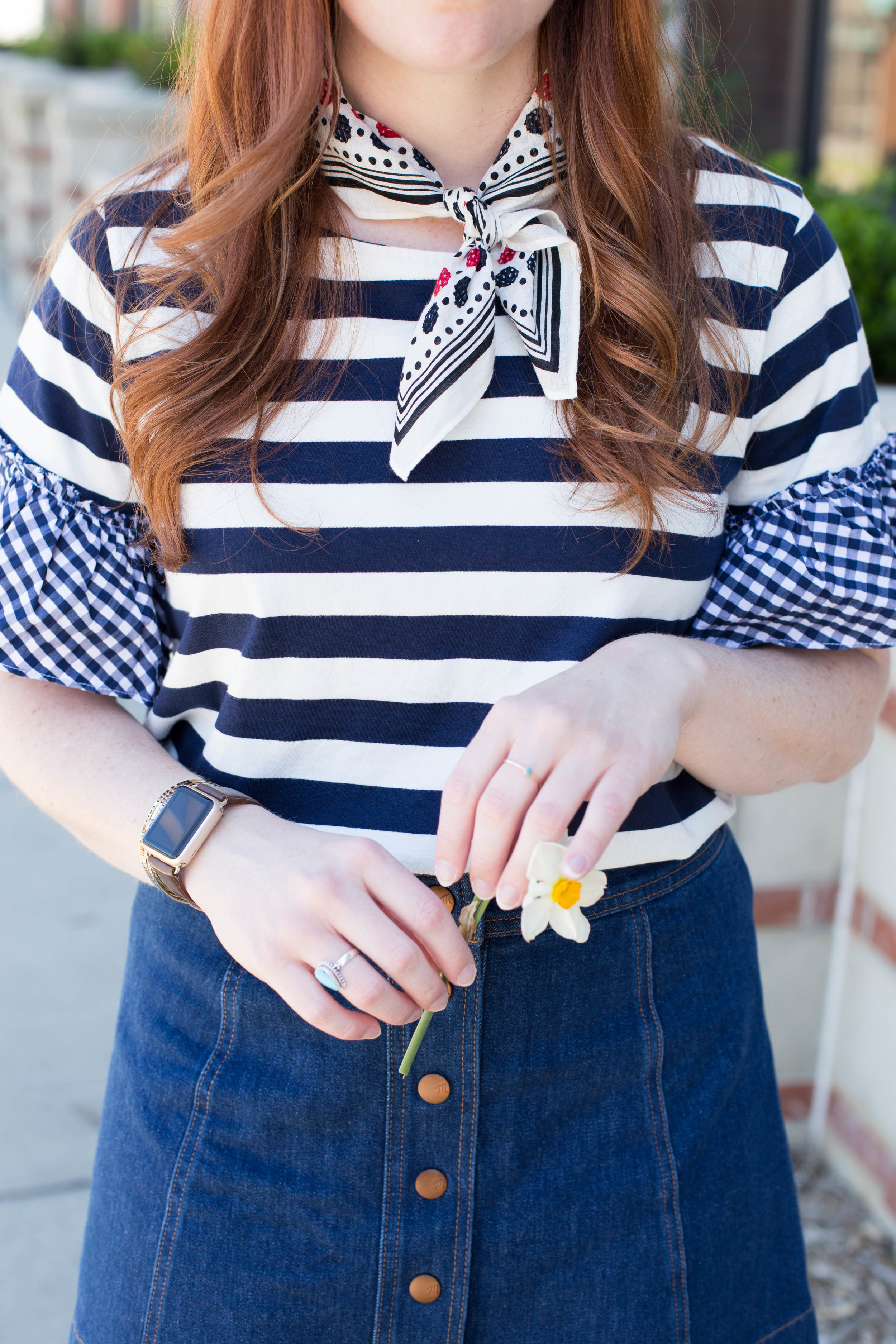 Adding a neck scarf to a simple blouse and flirty denim skirt is the perfect way to make a comfortable outfit unique. Find out more at www.thefashionablefoodieblog.com!