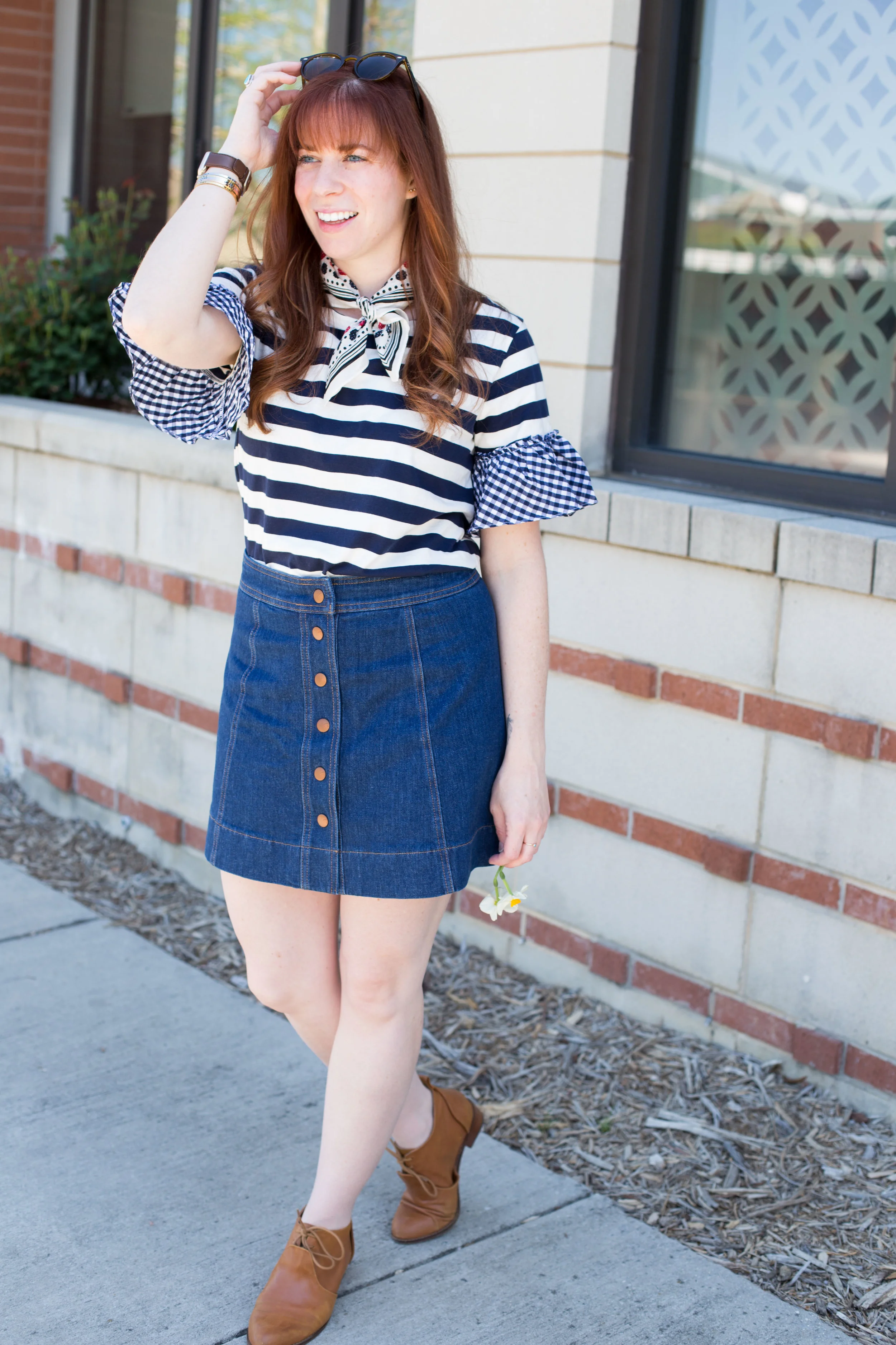Adding a neck scarf to a simple blouse and flirty denim skirt is the perfect way to make a comfortable outfit unique. Find out more at www.thefashionablefoodieblog.com!