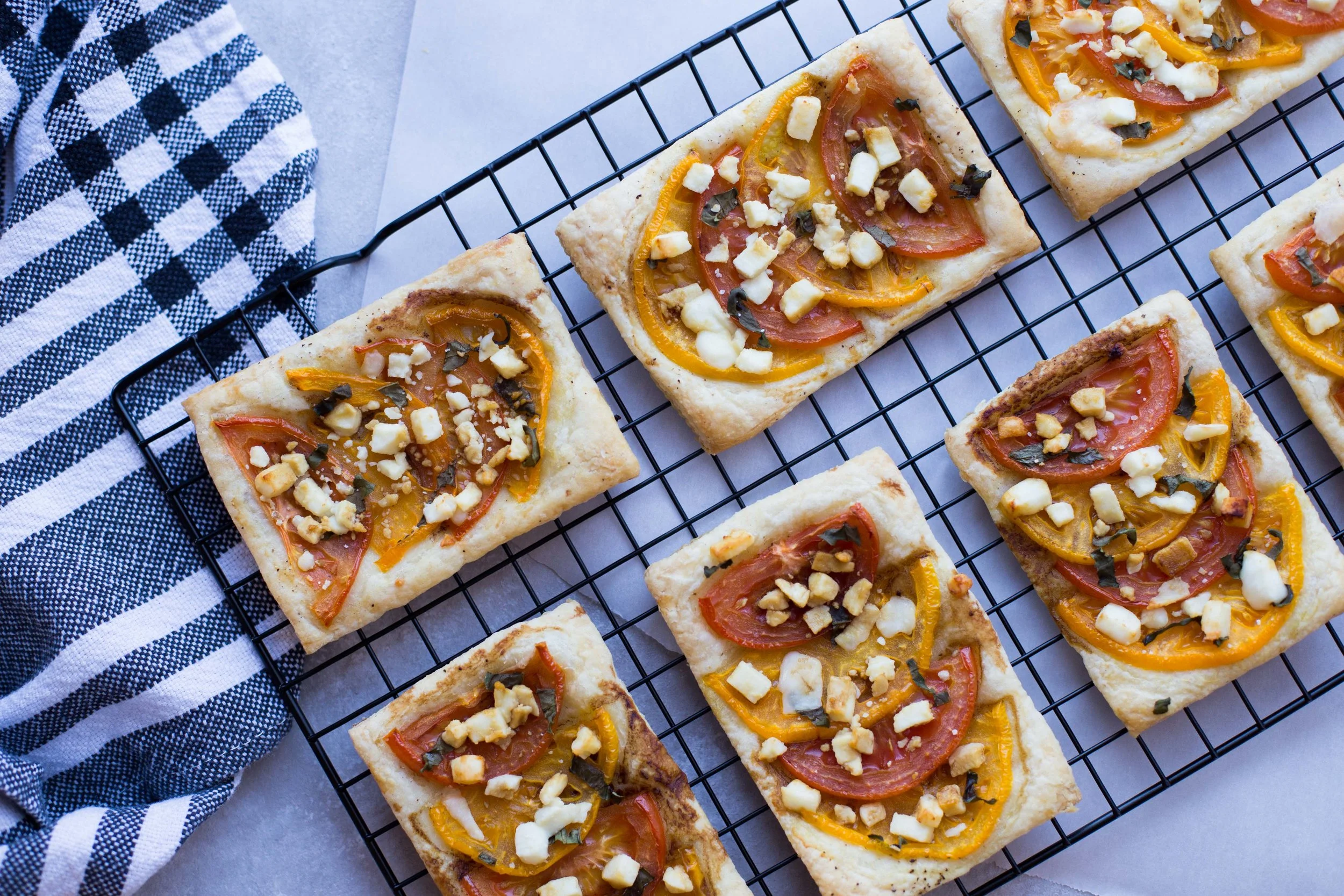 Summer Tomato Tarts with fresh basil, feta cheese, and balsamic drizzle. 