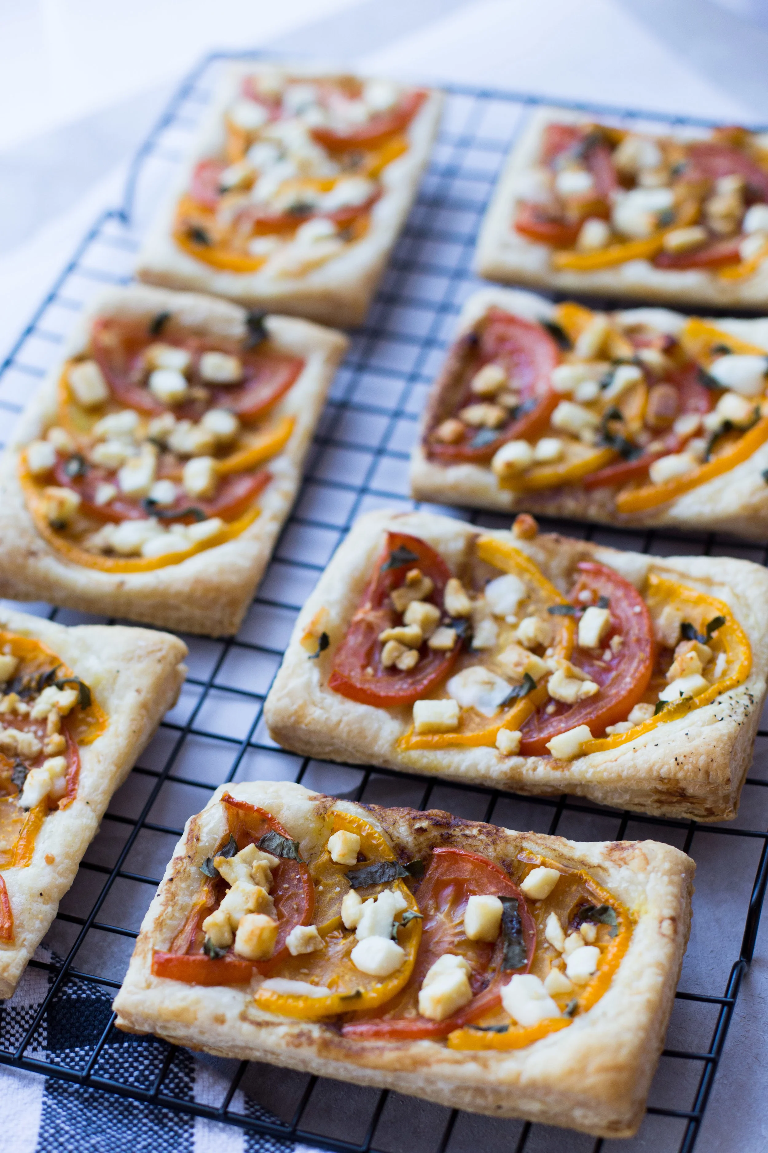 Summer Tomato Tarts with fresh basil, feta cheese, and balsamic drizzle. 