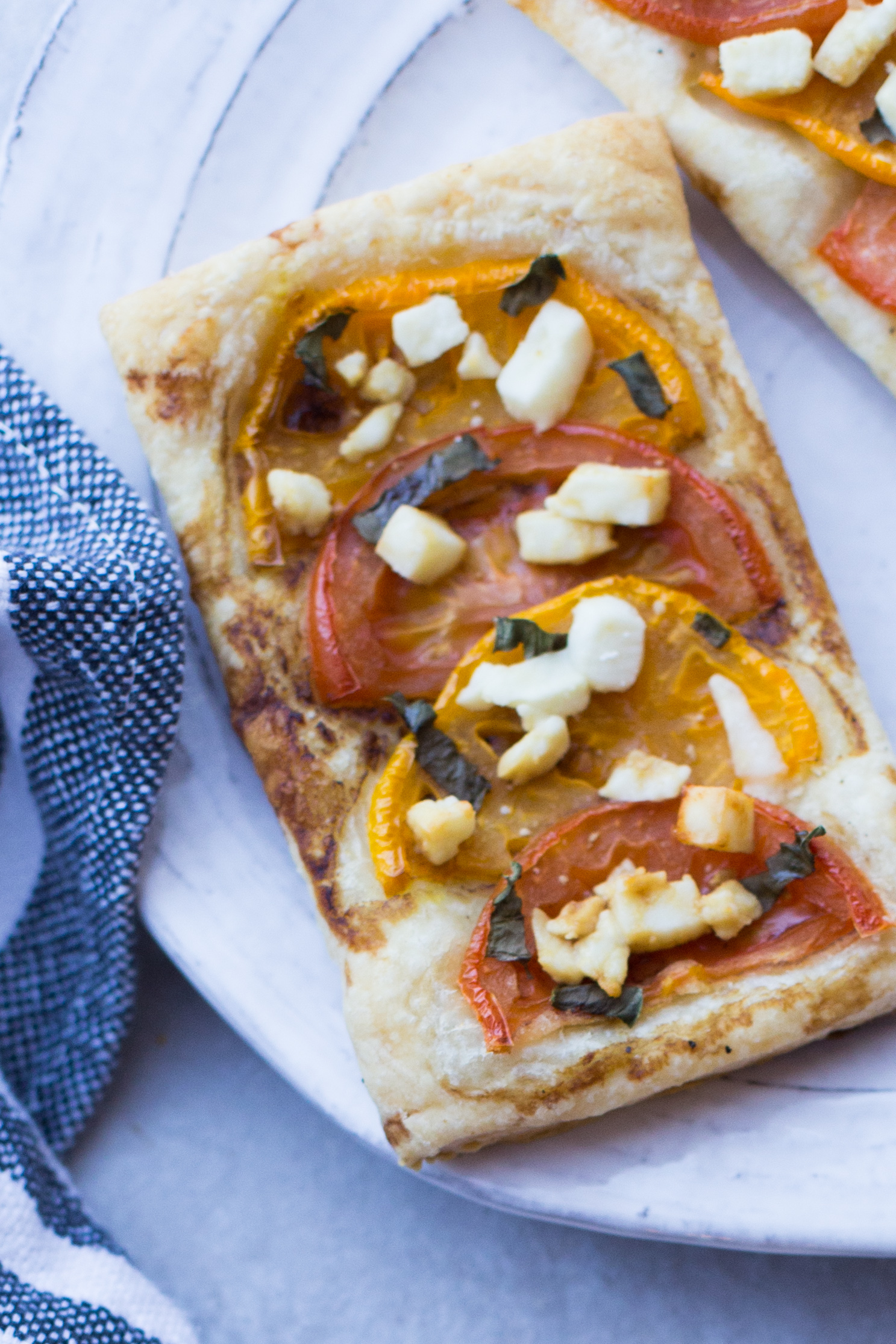 Summer Tomato Tarts with fresh basil, feta cheese, and balsamic drizzle. 