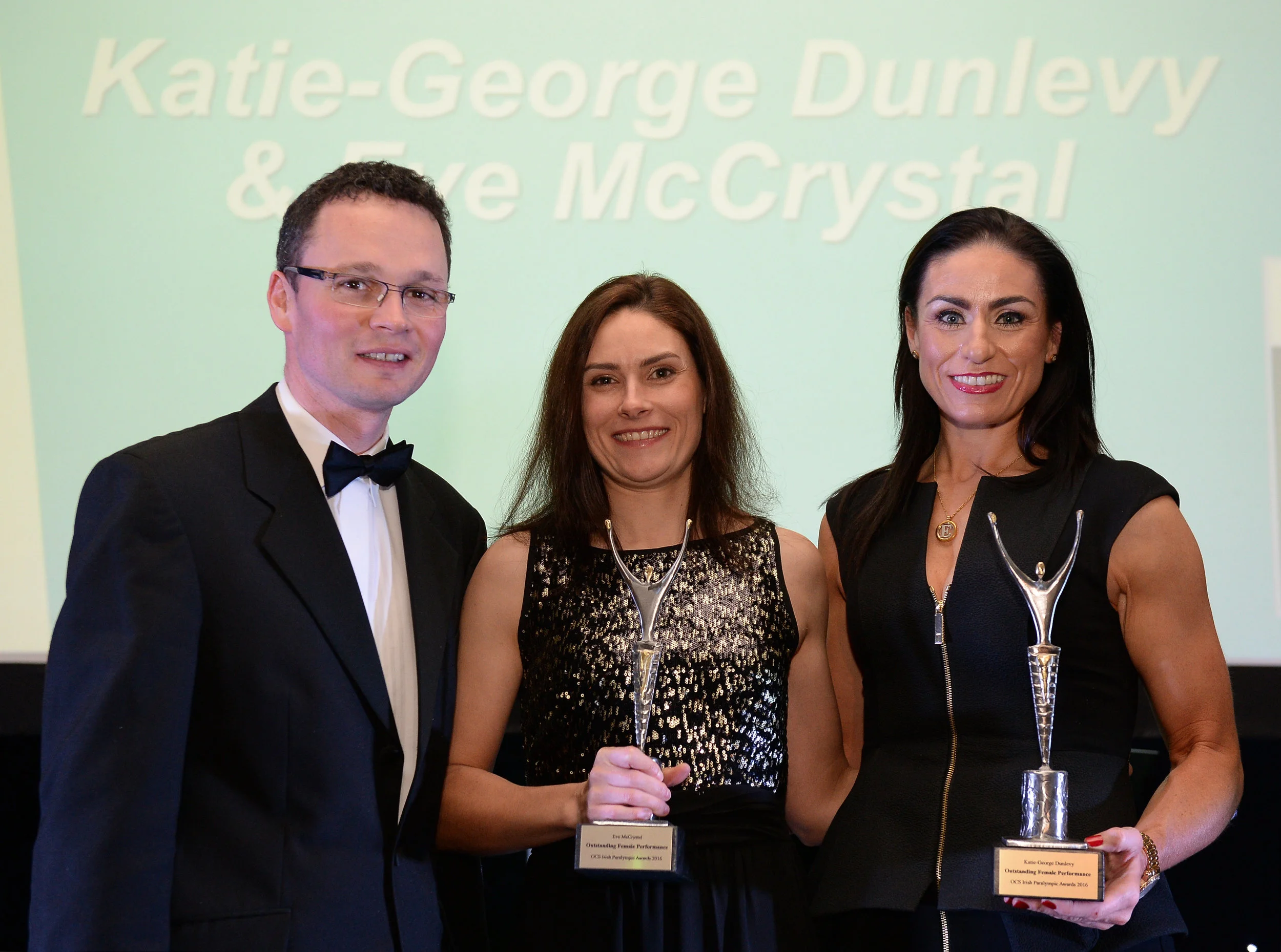 Katie-George Dunlevy, centre, and Eve McCrystal, accept their prize for Outstanding Female Performance, from Minister of State for Tourism and Sport Patrick O'Donovan T.D., at the OCS Irish Paralympic Awards