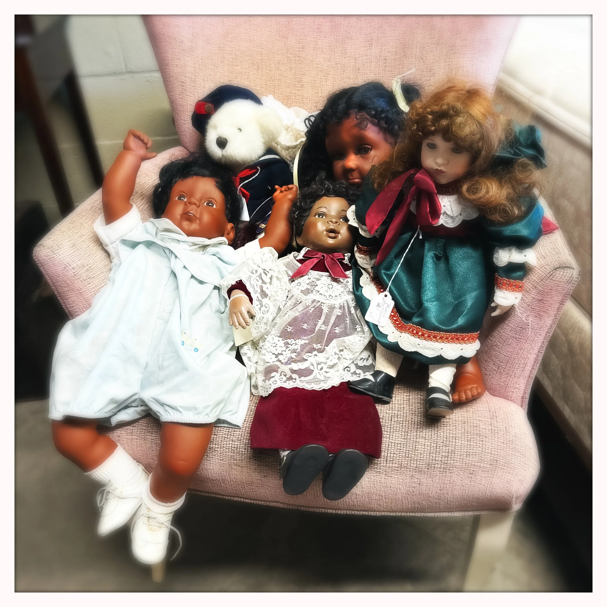 baby dolls on pink chair.jpg