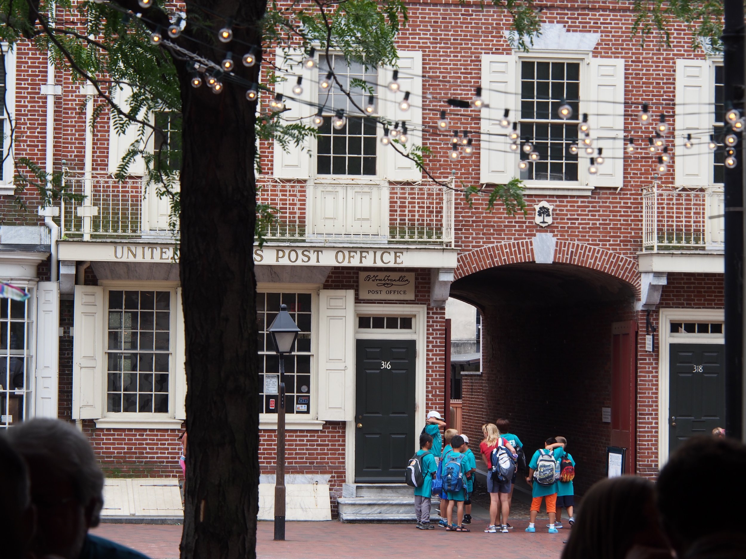Camp group on the street side entrance of the B. Free Post Office. The archway is the Market Street entrance to Franklin Court.