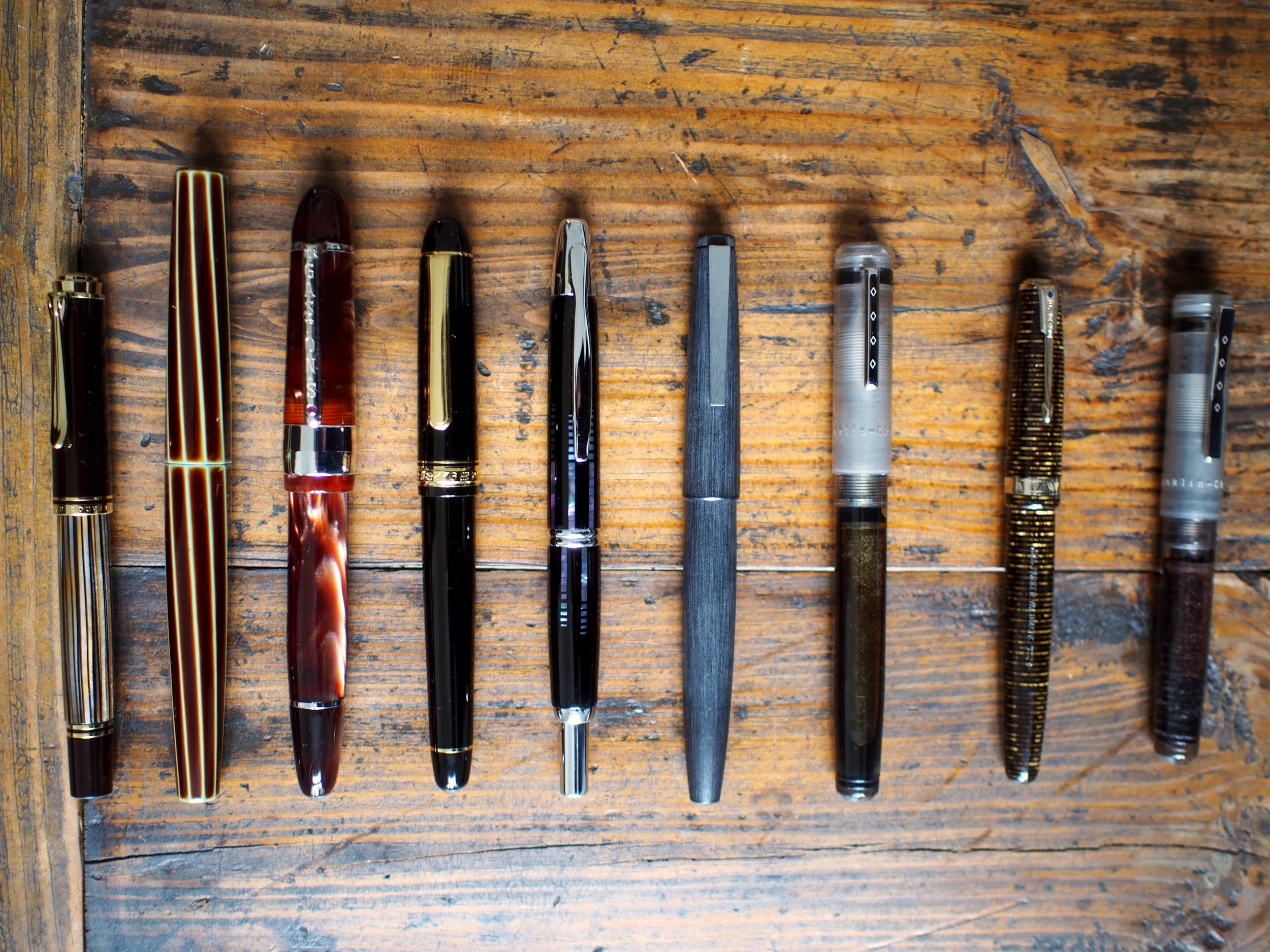 L-R: Pelikan M400, Nakaya Decapod Twist, Bexley Gaston's Special Reserve, Platinum 3776 Century, Pilot Vanishing Point, Lamy 2000, Franklin-Christoph Model 20, Parker Vacumatic Major Golden Pearl, Franklin-Christoph Pocket 20