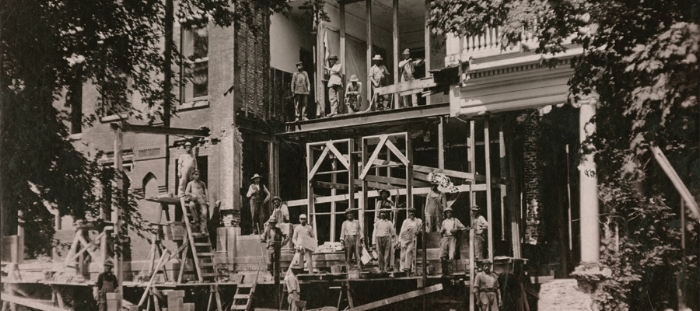  Historic photograph of workmen remodeling the Ellwood Mansion in 1912  Black and white photograph of about 20 workmen completing the 2nd major remodeling of the Ellwood Mansion&nbsp; Much of the south side of the building has been removed, to make w