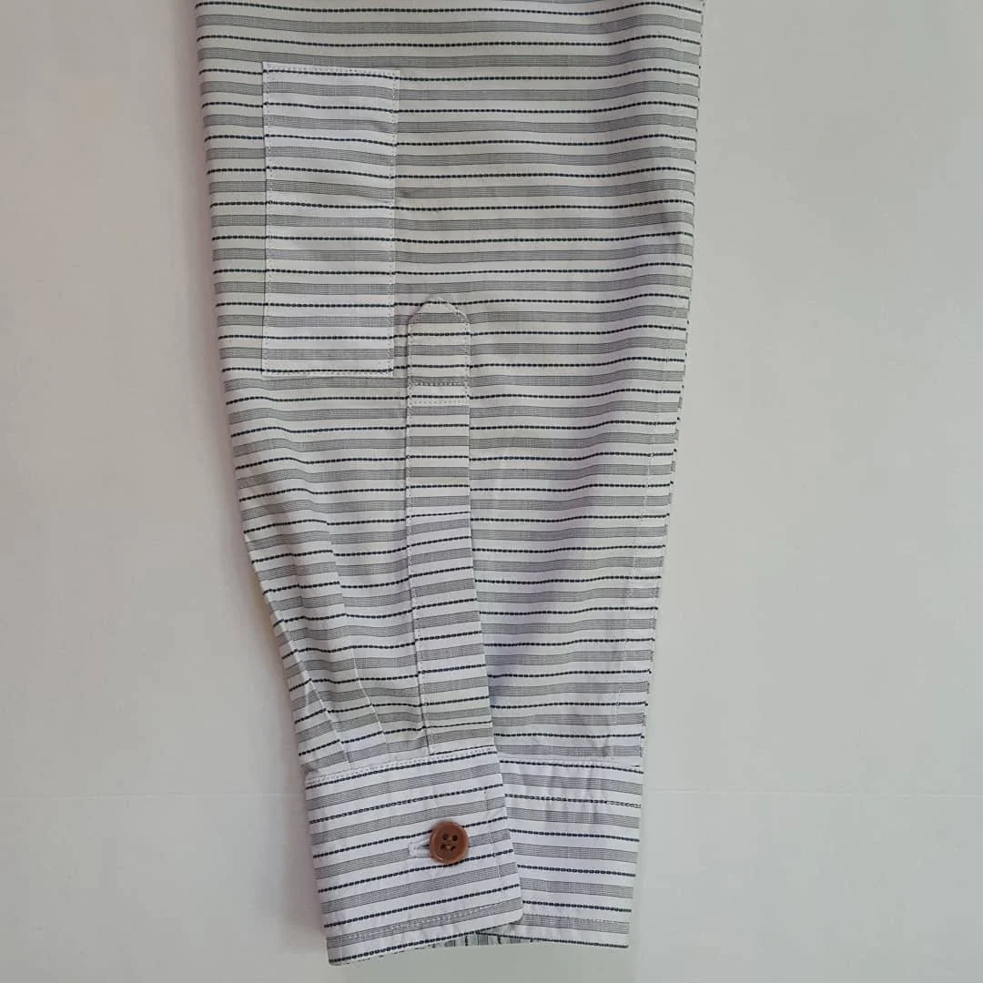 This is a shirt we made for a client two years ago. Recently she tripped on the pavement and scraped a hole in her sleeve. We had run out of this fabric a long time ago, so we could not replace the sleeve, but we found enough of it in our scrap box t