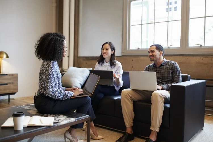 smiling-work-colleagues-with-laptops-at-a-casual-P2YJEVT.jpg