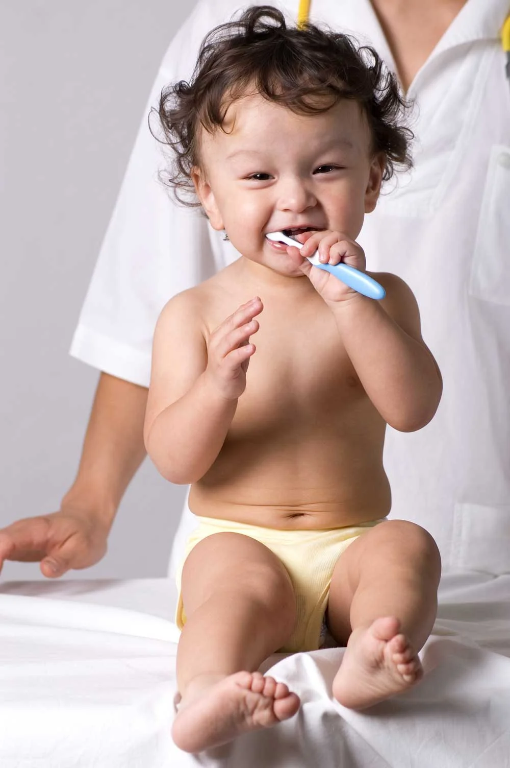Toddler smiling and brushing teeth