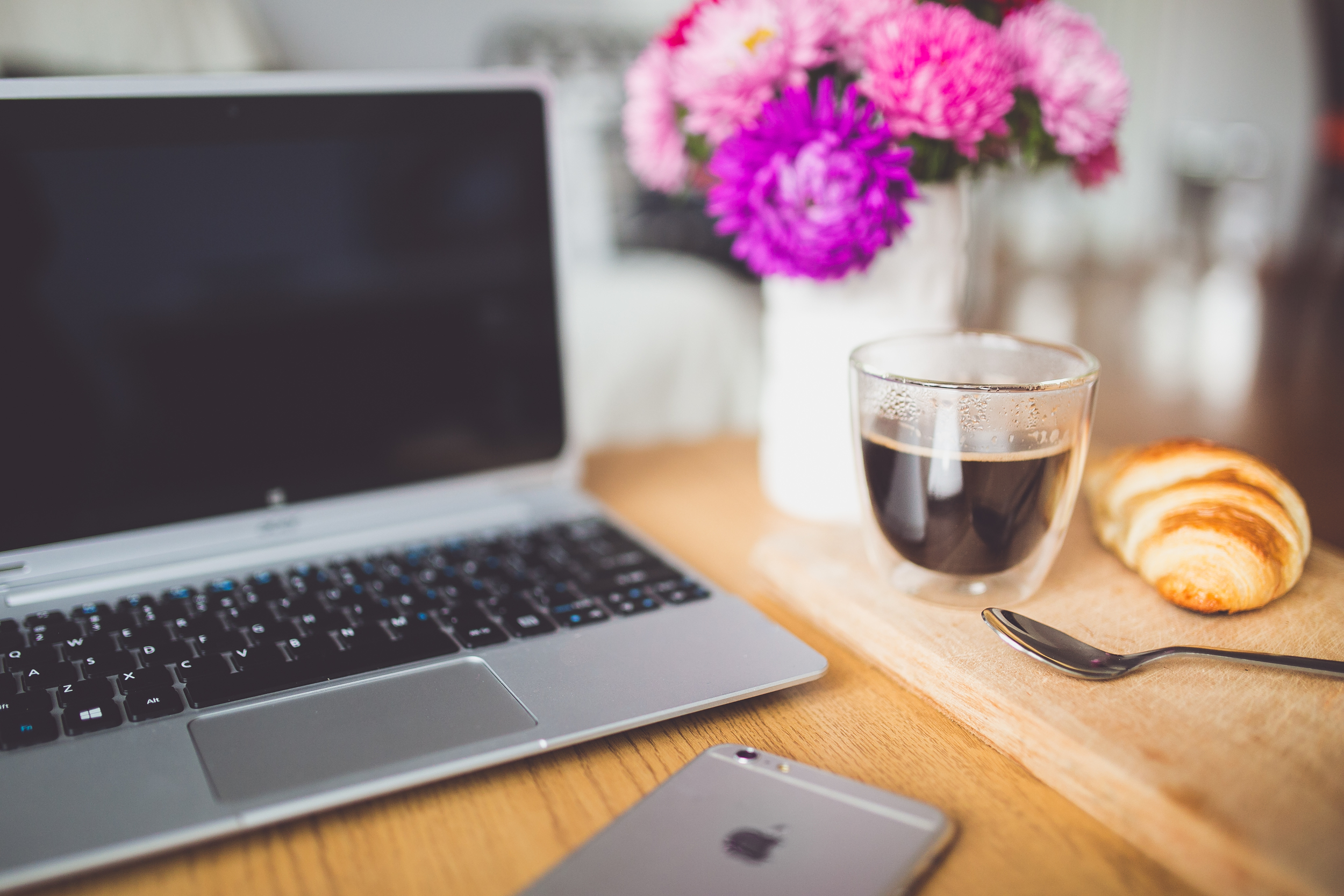 kaboompics.com_Workplace with notebook, cup of coffee and croissant.jpg