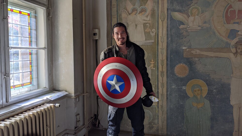 Desmond Chiam with the Captain America shield on the set of Falcon and the Winter Soldier. Photo from his Twitter.