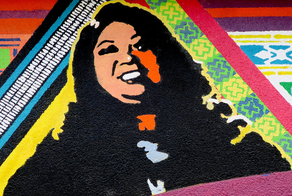 Dawn Mabalon in the mural at Arkipelago bookstore in San Francisco. Image from Heroes In Our Windows: Looking at the Making of a Mural in the South of Market (SOMCAN)