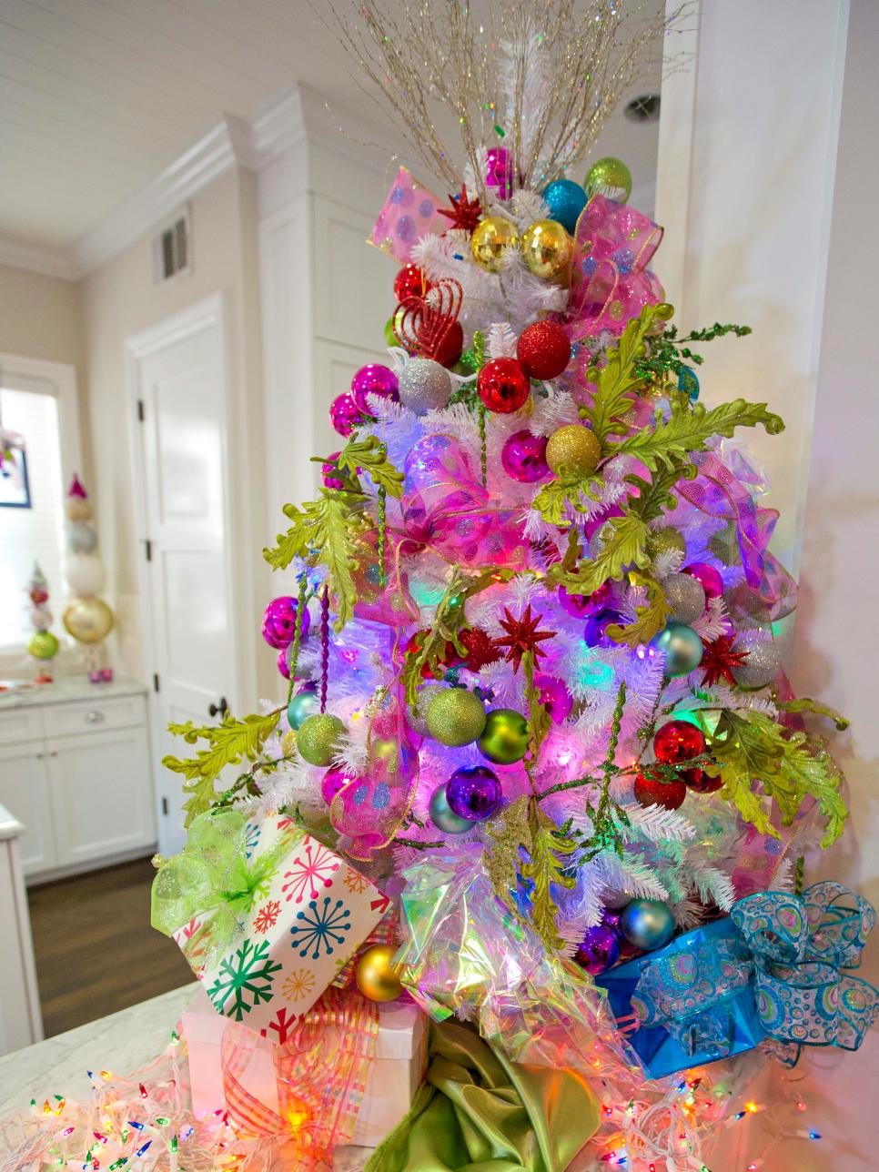 For the playful and eclectic Fashionista, this tree is the only option Leaves, ornaments, holographic paper and actual presents fill this tree on wonder.