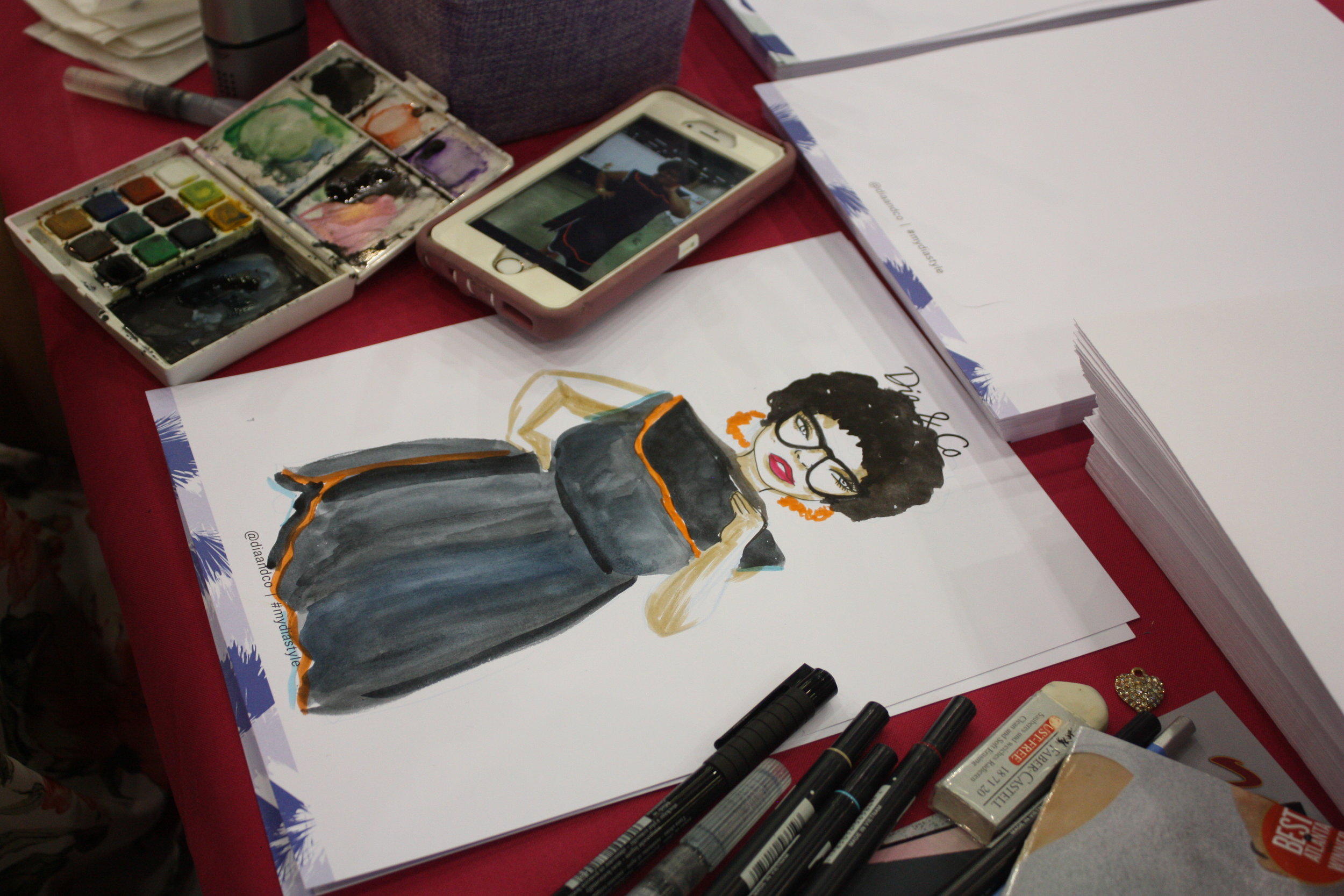Yep, that's me on the phone next to the drawing! I think she nailed it! Thanks Jonquel for capturing my signature pose!