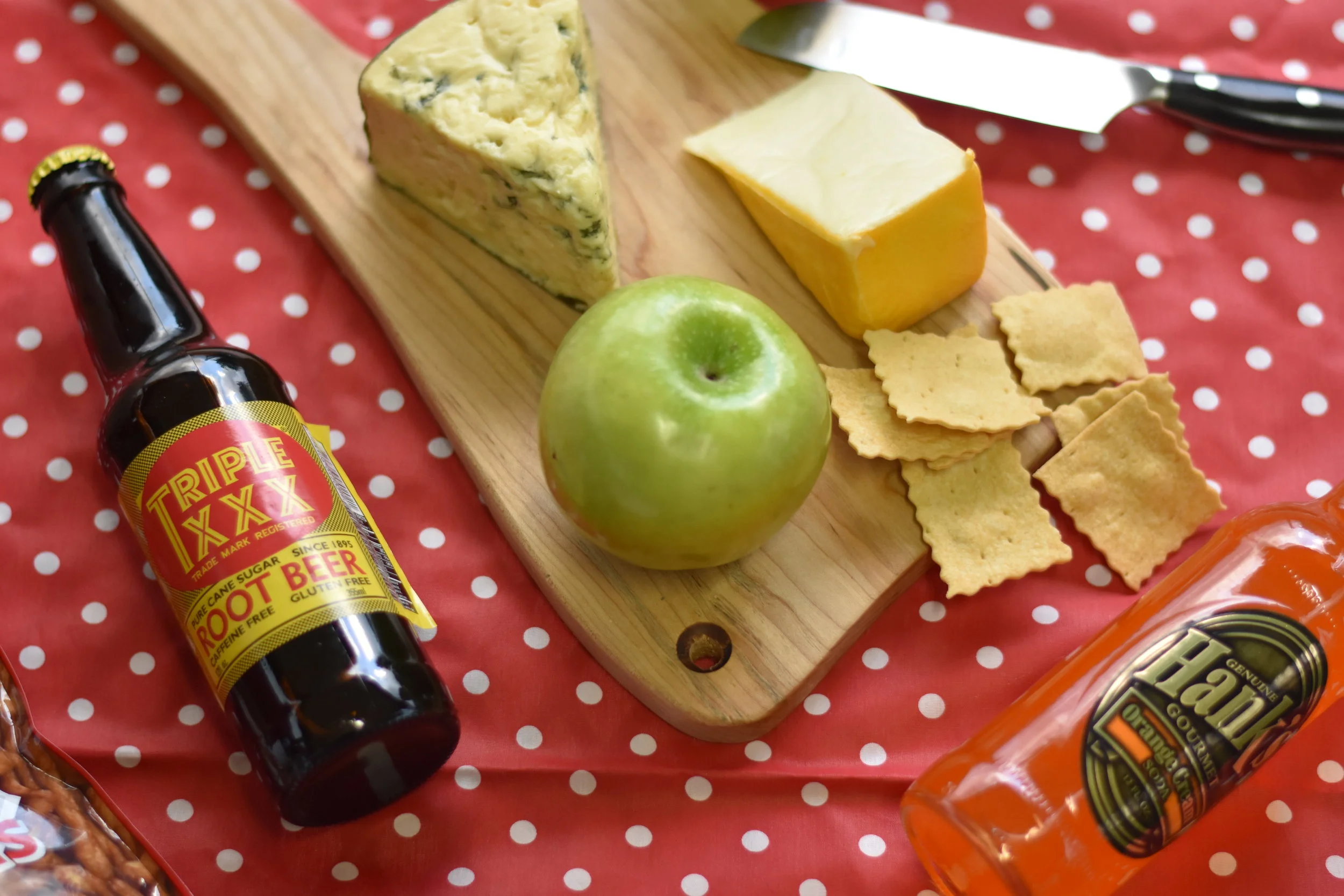 charcuterie board featuring several cheeses and crackers