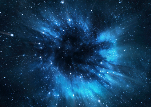 Gas and dust pulled towards a black hole, heat up and shine brightly as they spiral around the black hole. This is how scientists can tell where there is a black hole. © Getty Images