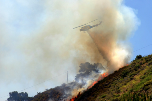 Helicopters and aircraft are used to water bomb the bushfire © Getty Images