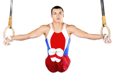 A gymnast holds steady on the still rings