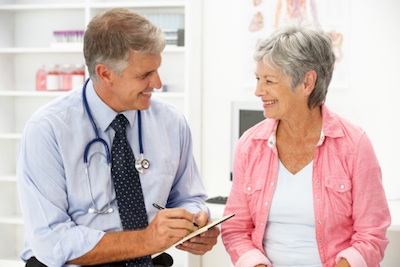 A doctor writes a prescription for medicine. Getty Images