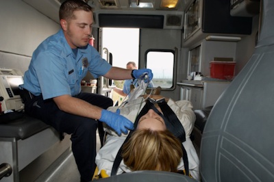 Inside the ambulance, a paramedic keeps watch on the patient until they reach the hospital. Getty Images