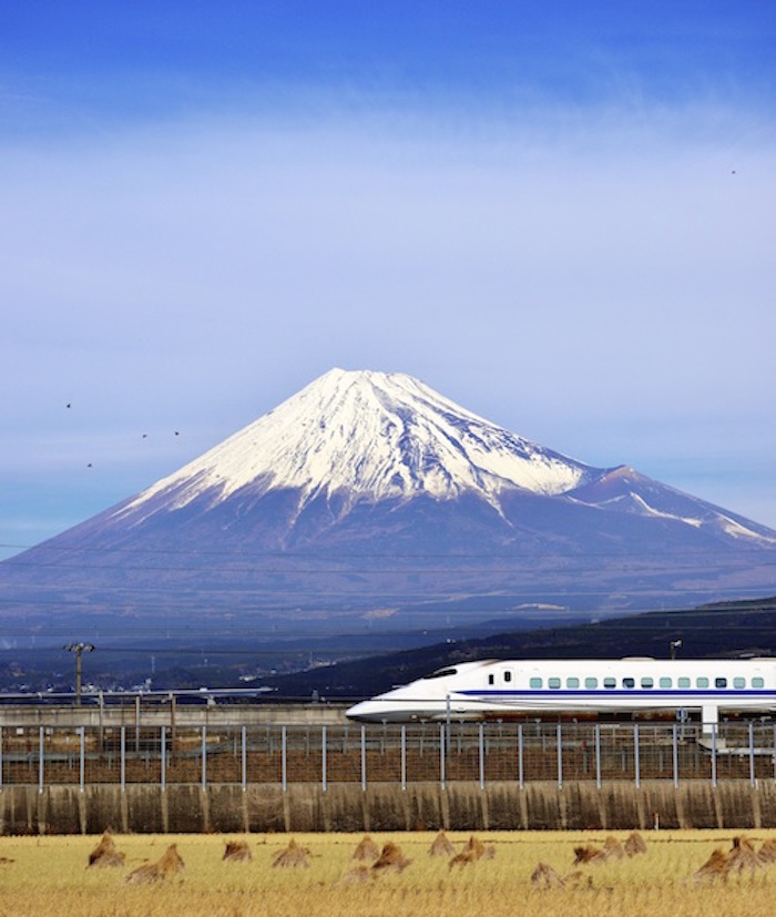 A bullet train speeds past Mt Fuji. Getty Images