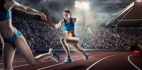 Runners in a relay race pass a baton to each other.© Getty Images