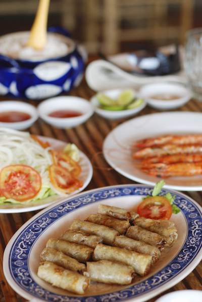Vietnamese meal including spring rolls, salad, soup. photo©Getty