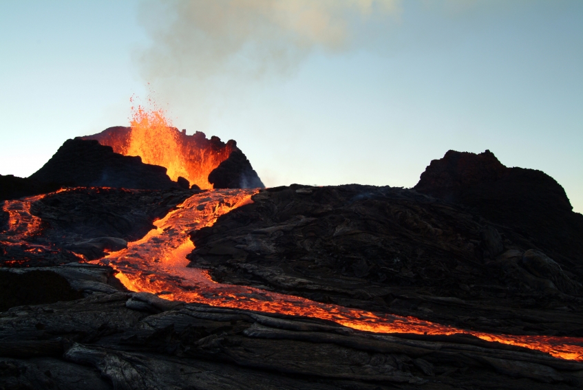 Hot lava flowing down the side of an erupting volcano. Getty Images