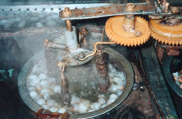 Hot water softens the sticky gum that holds the long single thread of each cocoon. Photo©kidcyber