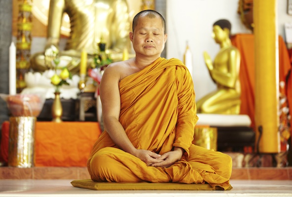 A Thai Buddhist monk meditating in a wat, or temple. Getty Images