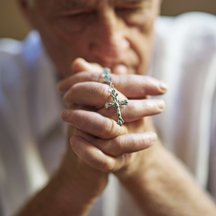People speak to God through prayer. The cross is one symbol of Christianity because Christ died on a cross. ©Getty Images