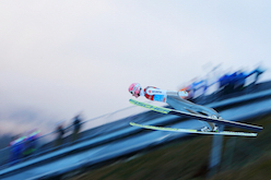 Ski jumping athletes 'fly' down the ski slope. © iStock/Getty Images