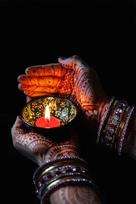 Hands painted with henna designs. The paint is made from the root of of the henna plant. ©iStock