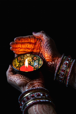 Hands painted with henna designs. The paint is made from the root of of the henna plant. ©iStock