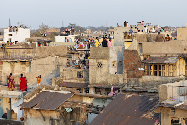 People crowd onto the rooftops to fly or watch kites. Photo ©Getty