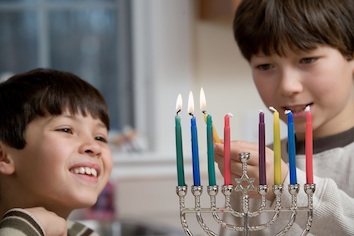 Lighting the menorah. Can you tell which night of Hanukkah it is?