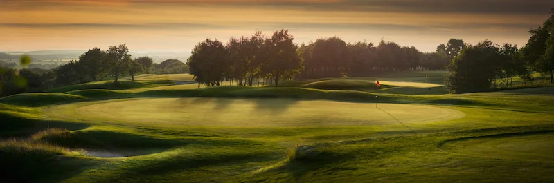 A golf course. Flags mark the holes on the greens. ©Getty