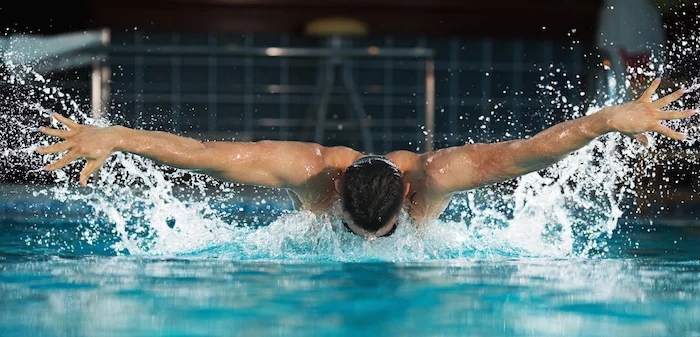 Butterfly swimmers lift both arms out of the water ©Getty