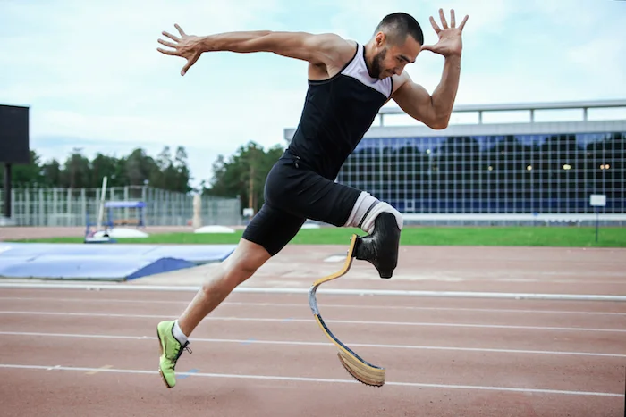 A sprinter bursts out of the blocks and down the track. The special artificial leg for running is called a prosthesis. ©Getty