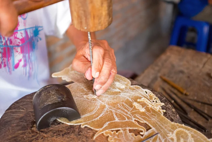  A wayang kulit puppet being made of buffalo hide. ©Getty