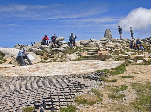Tourists on the summit of Mount Kosciuszko. ©iStock